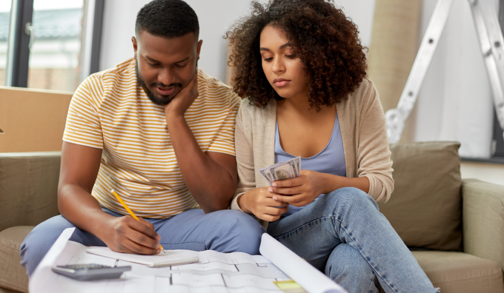 a couple carefully planning their travel on a budget