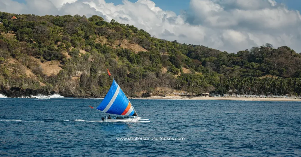 Vibrant sailboat cruising near the coast of Kihei—an inviting glimpse into sailing adventures and family fun in Hawaii.