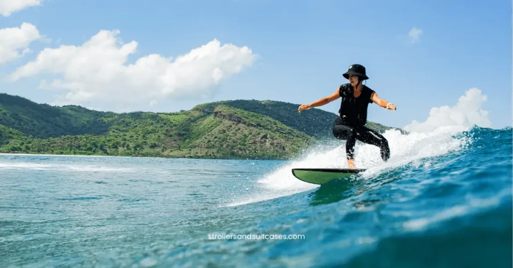 Woman surfing in Kailua, Hawaii – a fun, budget-friendly water activity for families who love the ocean.